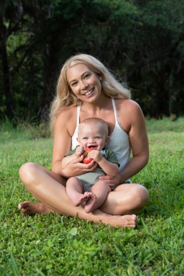 Emily and her son Cedar, ten months old in this photo. Cedar enjoys fresh veggies from the garden.