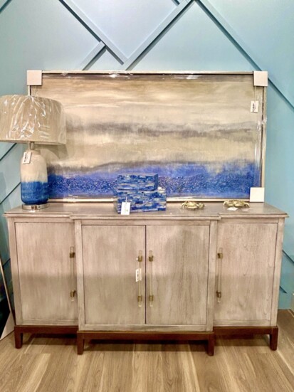 A weathered-looking wood cabinet evokes the coast, as does the blue accents in accessories and artwork.