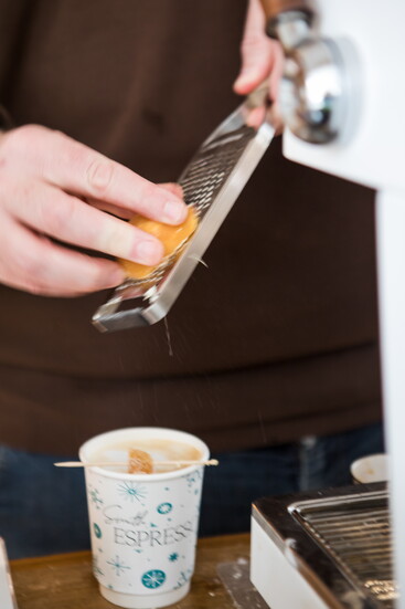 Brendan Smith adds a touch of flavor as he tops off a coffee drink. 