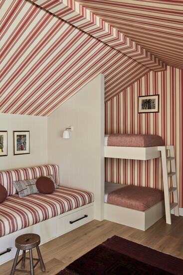 A bunkroom lined in striped fabric for a tent-like feel