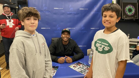 NFL Jets player at signing event. 