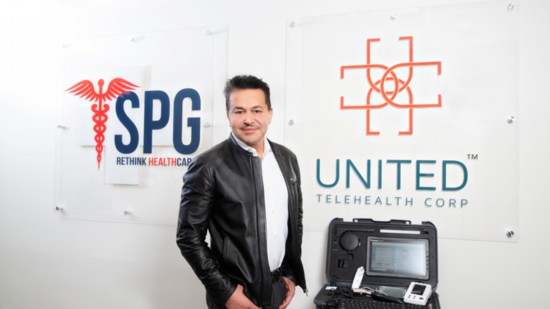 Dr. Nima Ghadimi, president of UTC and SPG, with a Transportable Exam Station (TES)