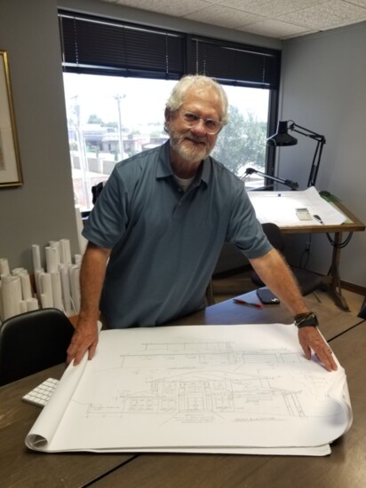 Gary Randolph displays the plans for the Prairie Style home he designed at his office in Nichols Hills.