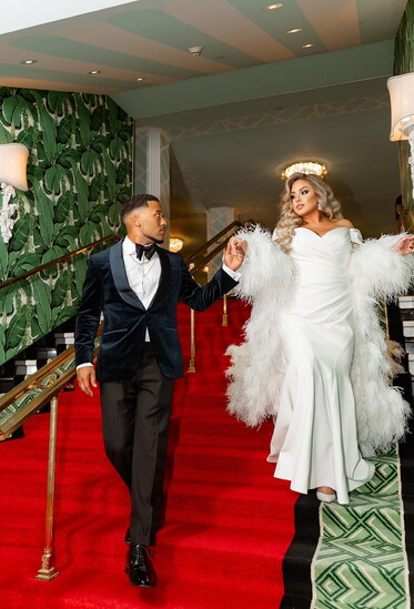 Photo by Chris Hiltz @tlicmedia at The Greenbrier Resort  Gown by Romona Kevesa Custom Suigens Ostrich feather cape by @suigens Tuxedo provided by Custom Suit S