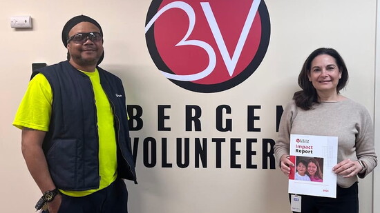 Bergen Volunteers CEO Shara Nadler holds the Impact Report at the office.
