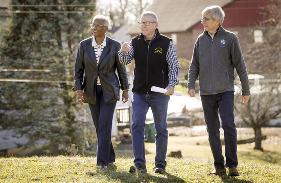 Rev. Paula Stewart, Larry Plum +  Earl Crossland walk the future site of Veterans Village behind Gaines UMC.