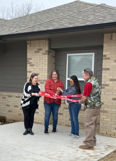 New homeowners, Rebecca and Jocelyn, cut the ribbons for their new homes in a public ceremony Feb. 2.
