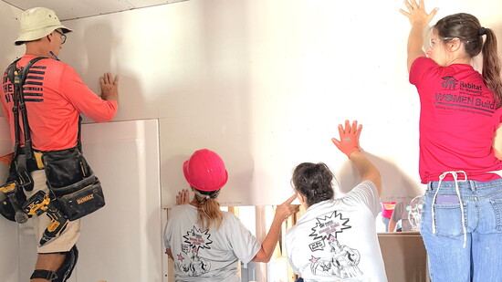 Future homeowner Bethany Stricker (right), with volunteers at Women Build.