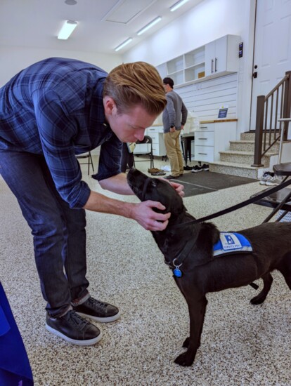 Ben with a black lab from Helping Paws 