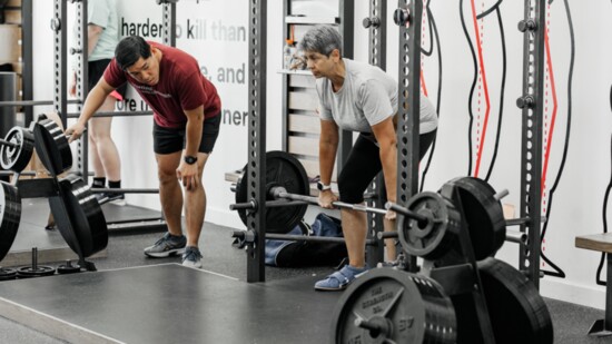 Pete ensures proper form is executed as Lynn Apel lifts.