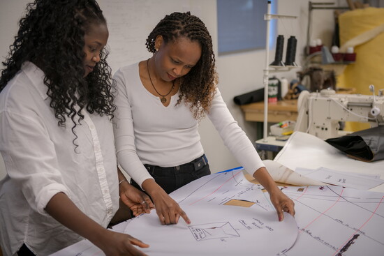 Peterson Canvas and Awning seamstresses, Milly and Adrin, review patterns and materials, where precision and craftsmanship shape every custom piece.