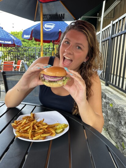 Madeline LeBlanc enjoys the classic burger at 7B's Burgers.