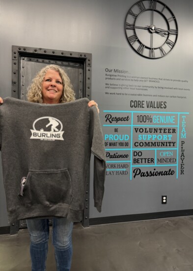 Tracy Lehmann of Bungalow Printing, BurlingNation's merchandise czar and original Board member, proudly displays the official BurlingNation hoodie.