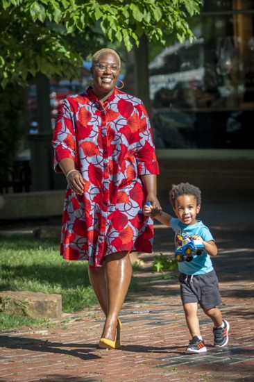 “I feel my best when I’m wearing bright colors and patterns that match my vibe,” says former DFS board member, Kuma Roberts. Dress by Zuri, shoes by ASOS.