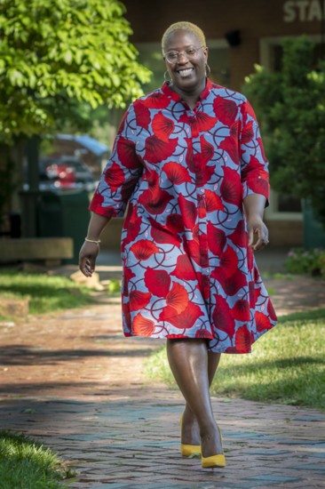 “I feel my best when I’m wearing bright colors and patterns that match my vibe,” says former DFS board member, Kuma Roberts. Dress by Zuri, shoes by ASOS.