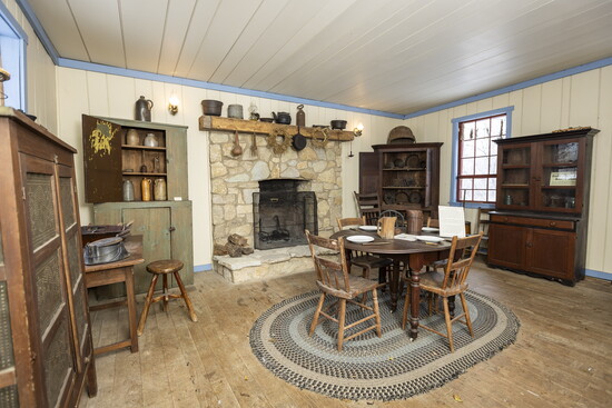 The interior of the DeWitt log home is primitive, but cozy + neat as a pin.