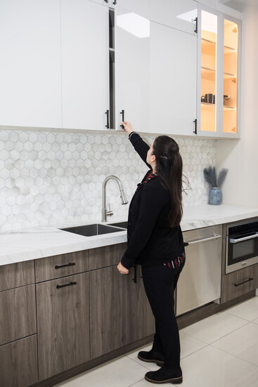 Patricia checks out cabinets in the showroom. 