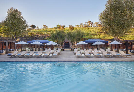 A view from the hotel across the pool towards the spa and vineyards.
