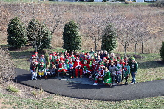 A group of volunteers called the Elf Squad dress up each year to deliver presents, holiday cheer, ornaments, blankets, and stuffed animals to patients.