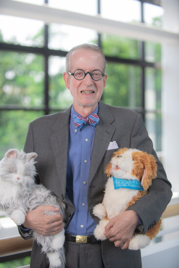 Stephen Cone, Capital Caring's chief of communications, marketing and philanthropy, displays the innovative robotic pets that support hospice patients. 