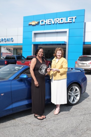 Wanda Cronic Howell presents keys to a happy buyer