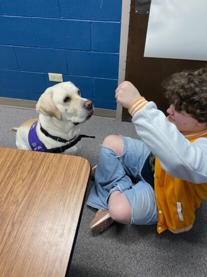 Rocky working with a local student.