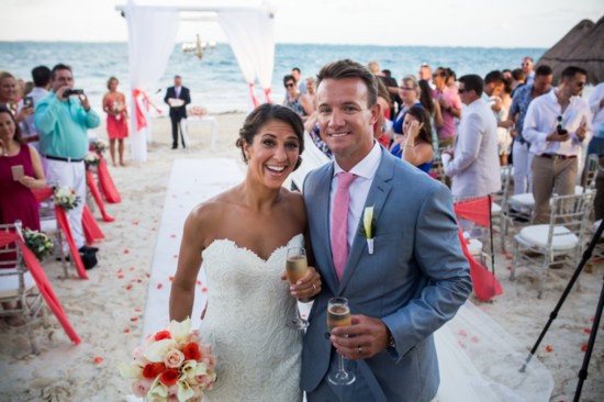 Carli and Brian celebrate after being married on a beach in Mexico in November 2016.