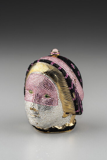 Judith Leiber (American, 1921 – 2018). Masquerade Head Minaudiere, 1989, gold-plated brass, leather, Swarovski crystals, semiprecious cabochon stone. 