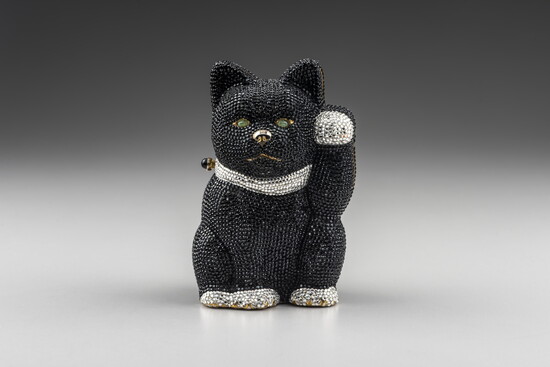 Judith Leiber (American, 1921–2018). Beckoning 'Killer' Cat Minaudiere, c. 1994, gold-plated brass, leather, Swarovski crystals, semiprecious cabochon stones. 