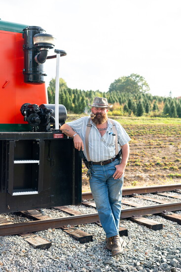 John Cavanna, next to one of his train engines.
