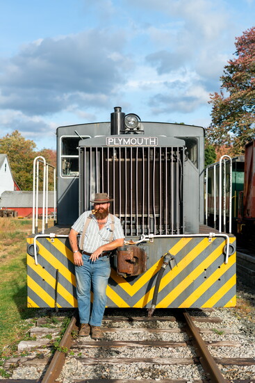 John Cavanna, next to one of his train engines.