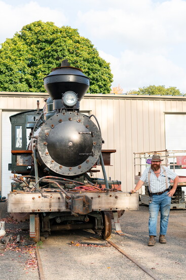 John Cavanna, next to an antique train engine he recently acquired. 