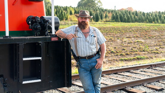 John Cavanna, next to one of his railroad engines.