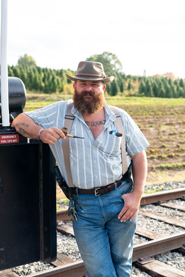 John Cavanna, next to one of his railroad engines.