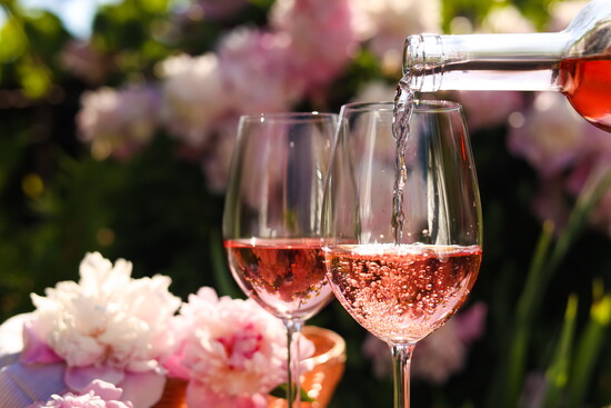 Rosé wine being poured into glasses.