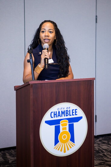 Shannon Wiggins, public relations and communications director for the city of Chamblee, addresses the crowd at the recent birthday celebration. 
