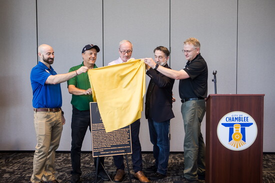 City officials unveil the plaque at the recent birthday celebration.