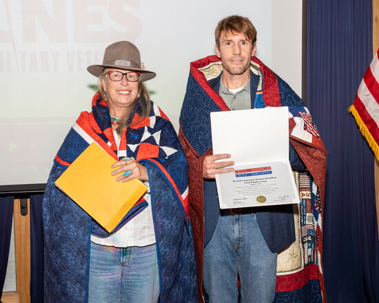 Veterans Nora Salavar and Dr. Michael Hamilton receive custom quilts from Quilts of Valor at the Boots & BBQ event.