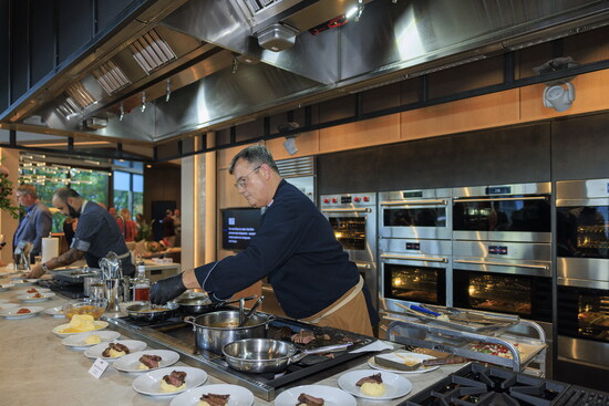 Chef George in action, preparing for the Grand Reopening event demonstrating the performance of premium appliances.