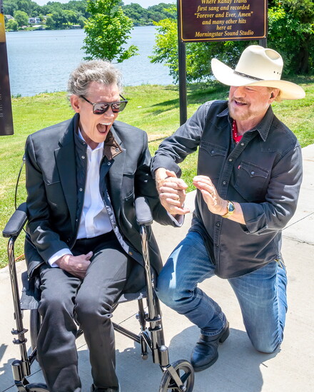 Randy Travis shares a moment with singer/songwriter Paul Overstreet.