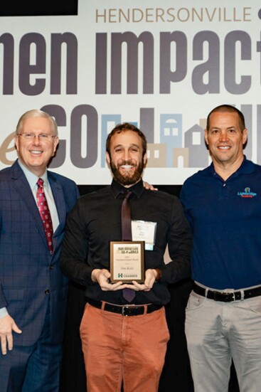 Tim Koly accepts the Education Impact award.