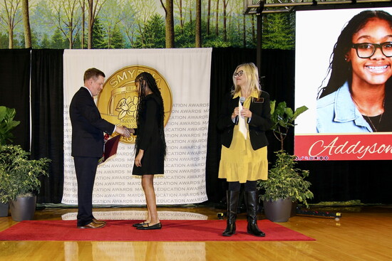 Griffin Middle School's Addyson Cordy accepts her award from Mayor Derek Norton