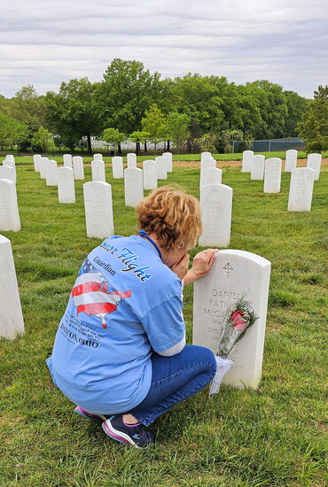 Lori McCarthy, visiting her husband's grave at Arlington National Cemetery for the first time. Lori was a also a guardian. Photo By: Alan Bailey