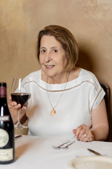 Nonna Elda enjoys a glass of wine at Via Emilia Italian Restaurant.