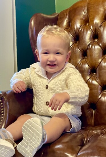 Tom's grandson Henry is in a handknit sweater 