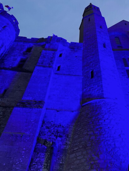 Mont-Saint-Michel etched in colored light.