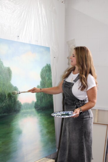 Carla Gignilliat adds finishing touches to a recent painting.