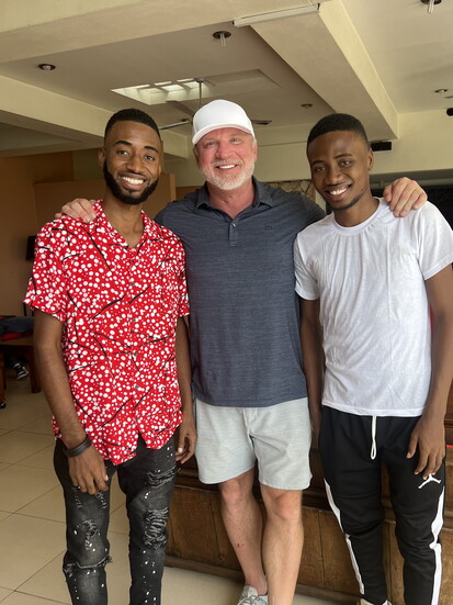 Jeff with two former orphans, one of whom just opened a primary school for children in poverty