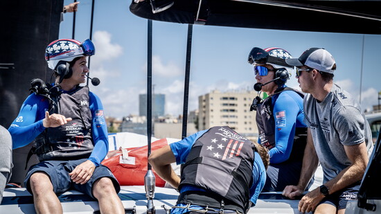 American Magic's Lucas Calabreses, Paul Goodison, and Riley Gibbs hold short briefing before training.