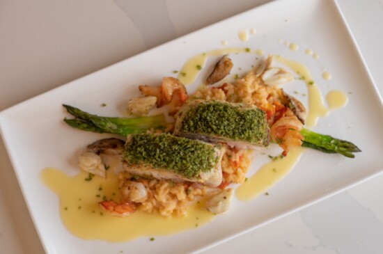 Shrimp and crab crusted triple tail with asparagus served over a tomato risotto with lemon capers. 